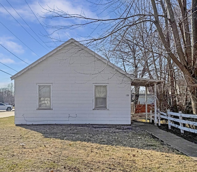 view of side of home featuring fence