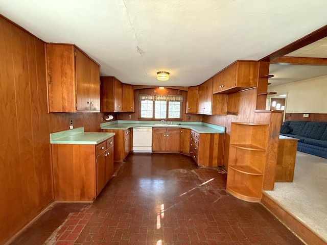 kitchen featuring brown cabinets, open shelves, wooden walls, brick floor, and dishwasher