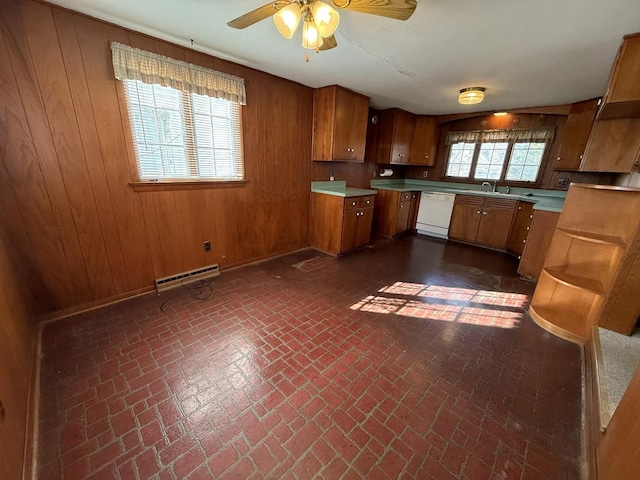 kitchen featuring brown cabinetry, wood walls, and dishwasher