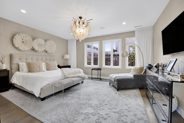 bedroom with recessed lighting, visible vents, baseboards, and wood finished floors