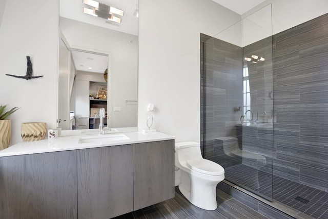 full bath featuring vanity, toilet, and a stall shower