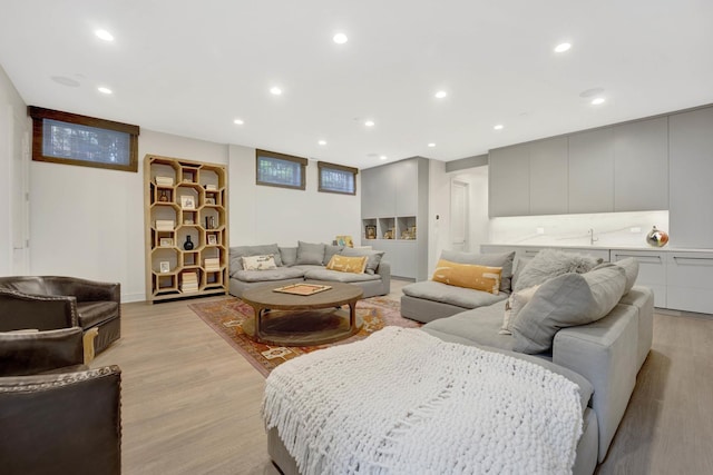 living area with recessed lighting and light wood-style flooring