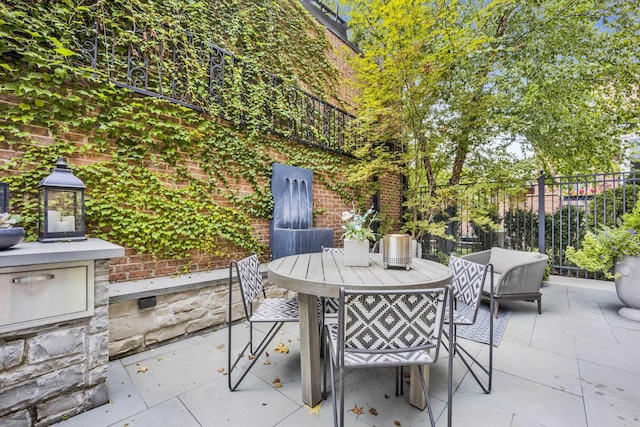 view of patio / terrace with outdoor dining area and fence