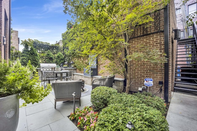 view of patio with stairs and outdoor dining area