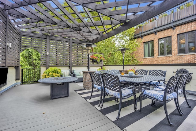 deck featuring a pergola and outdoor dining area