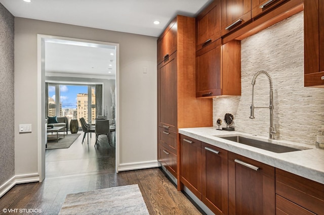 77 E Walton Pl Unit 24E, Chicago, IL 60611 - kitchen featuring a sink, dark wood finished floors, decorative backsplash, recessed lighting, and baseboards