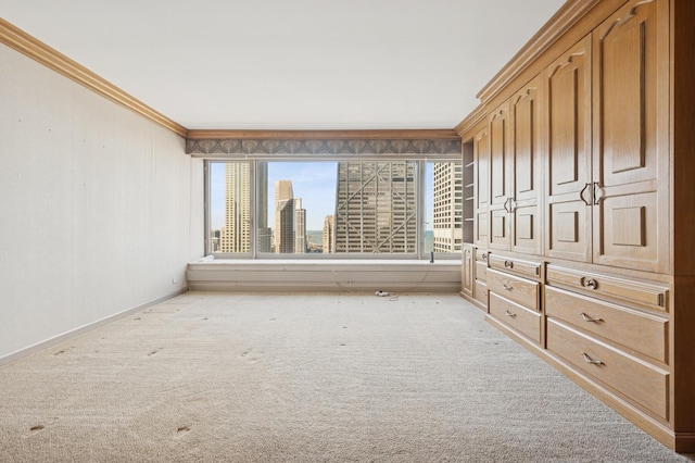 unfurnished room featuring baseboards, a view of city, light colored carpet, and ornamental molding