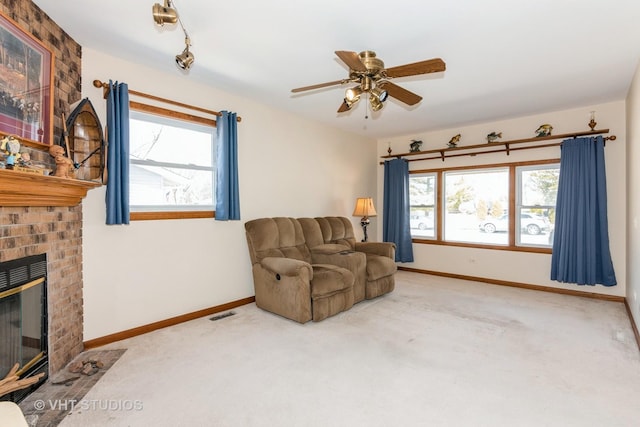 sitting room with baseboards, carpet floors, a healthy amount of sunlight, and a fireplace