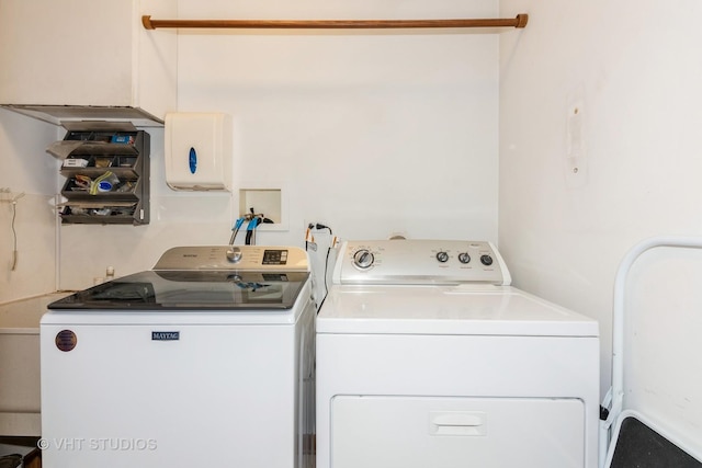 clothes washing area featuring laundry area and washer and dryer