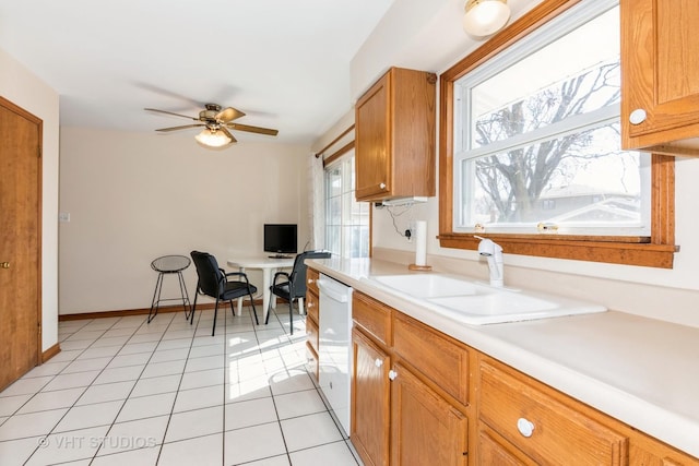 kitchen with a ceiling fan, a sink, light countertops, light tile patterned floors, and dishwasher