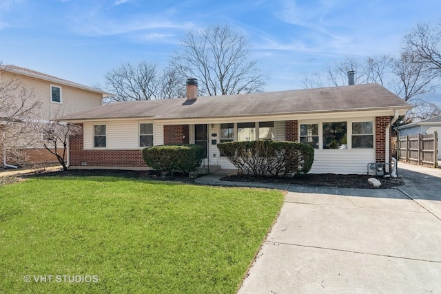 ranch-style home featuring brick siding, a chimney, a front lawn, and fence