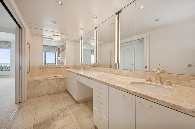 full bath with a sink, a bath, double vanity, and tile patterned flooring