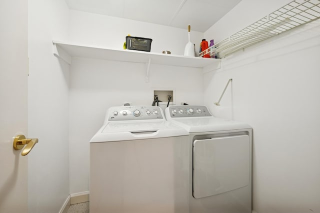 laundry room featuring washing machine and clothes dryer, laundry area, and baseboards