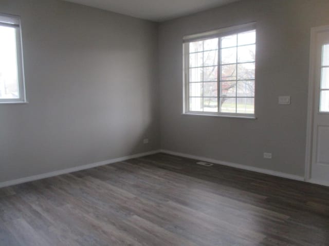 entrance foyer featuring baseboards and wood finished floors