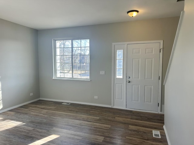 entryway with visible vents, baseboards, and dark wood finished floors