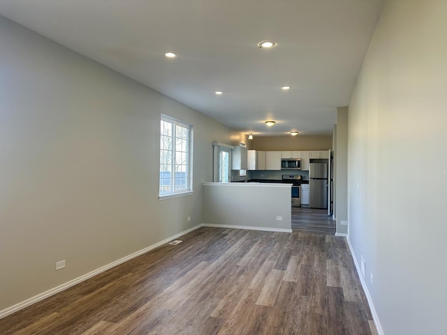 121 S Annandale Dr, Lake In The Hills, IL 60156 - unfurnished living room with recessed lighting, dark wood-style floors, and baseboards