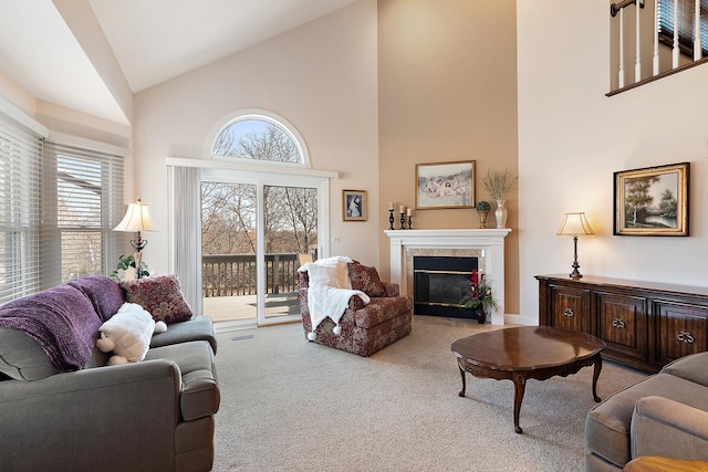 living area with carpet floors, high vaulted ceiling, and a fireplace