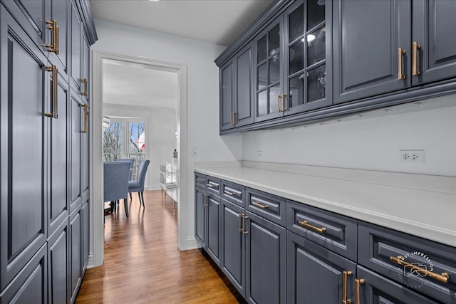 bar featuring baseboards and wood finished floors