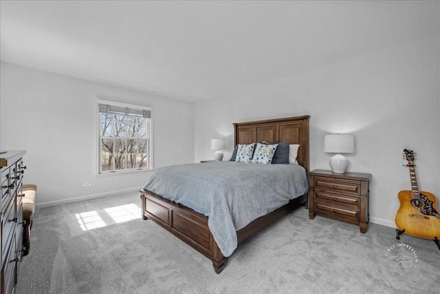 bedroom with light carpet and baseboards