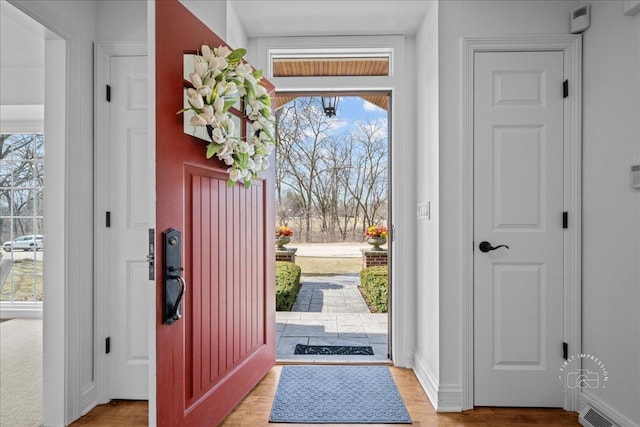 entrance foyer featuring light wood finished floors, visible vents, and baseboards