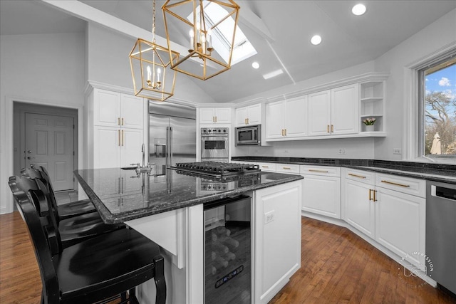 kitchen featuring beverage cooler, built in appliances, lofted ceiling, white cabinets, and open shelves