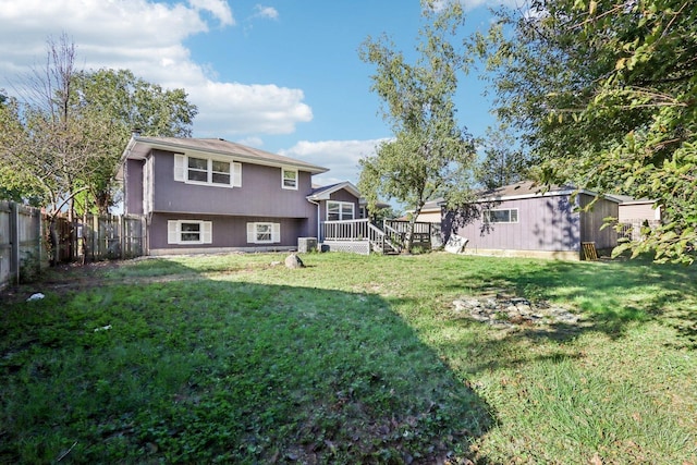 view of yard with fence and a wooden deck