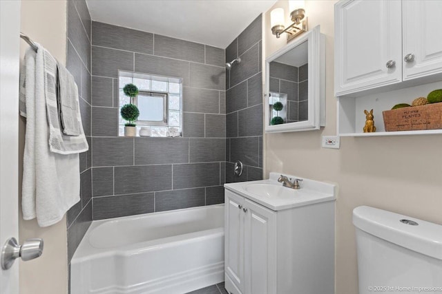 bathroom featuring vanity, shower / tub combination, and toilet