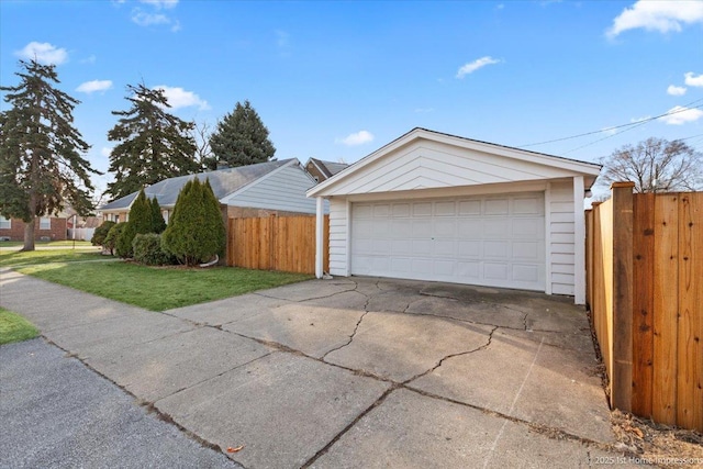 view of front of home with a garage, a front yard, and fence