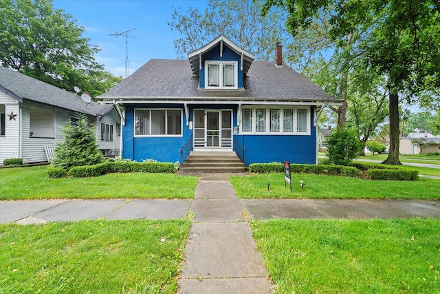 896 S Myrtle Ave, Kankakee, IL 60901 - bungalow with a front lawn, a chimney, roof with shingles, and stucco siding