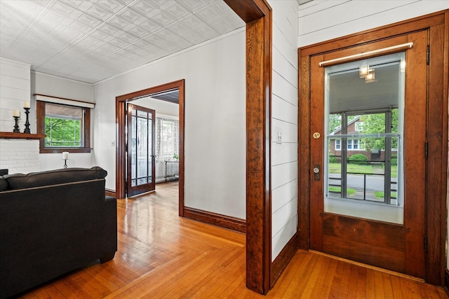896 S Myrtle Ave, Kankakee, IL 60901 - entrance foyer with an ornate ceiling, light wood-type flooring, baseboards, ornamental molding, and wooden walls
