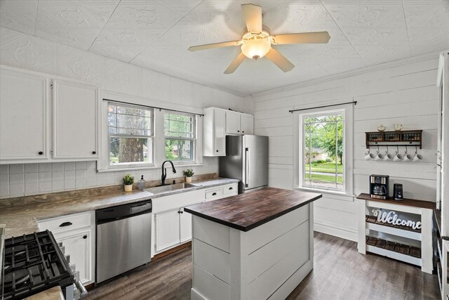 896 S Myrtle Ave, Kankakee, IL 60901 - kitchen with stainless steel appliances, a sink, dark wood-style floors, butcher block counters, and white cabinets