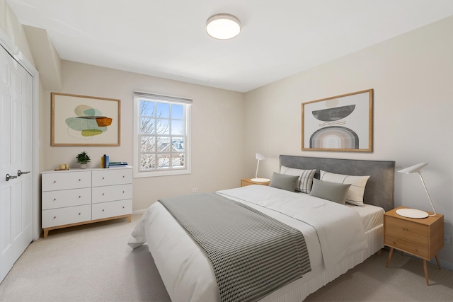 bedroom with a closet and light carpet