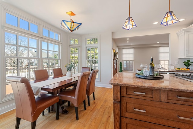 dining area with light wood-style flooring, recessed lighting, and baseboards