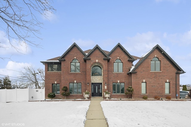 view of front of property with fence and brick siding