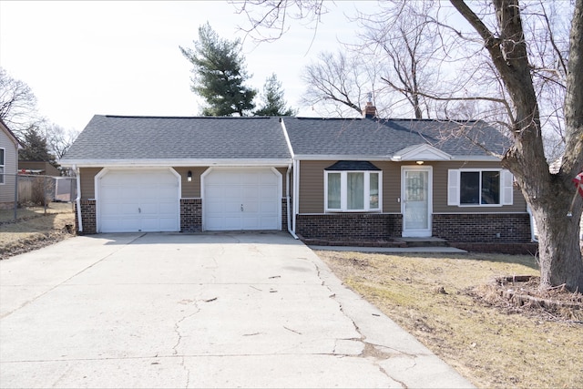 ranch-style house featuring an attached garage, brick siding, driveway, and a chimney