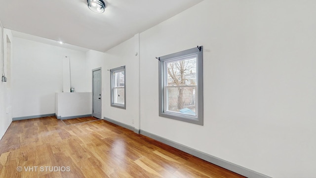 foyer with baseboards and light wood-type flooring