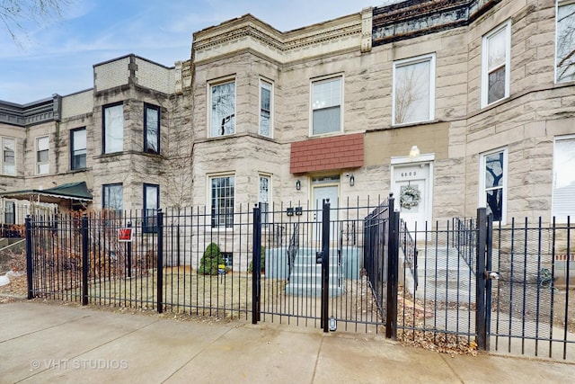 view of property featuring a fenced front yard and stone siding