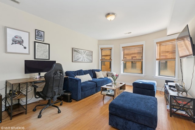 office with visible vents, baseboards, and hardwood / wood-style flooring