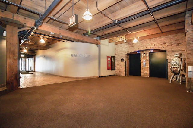 basement featuring brick wall