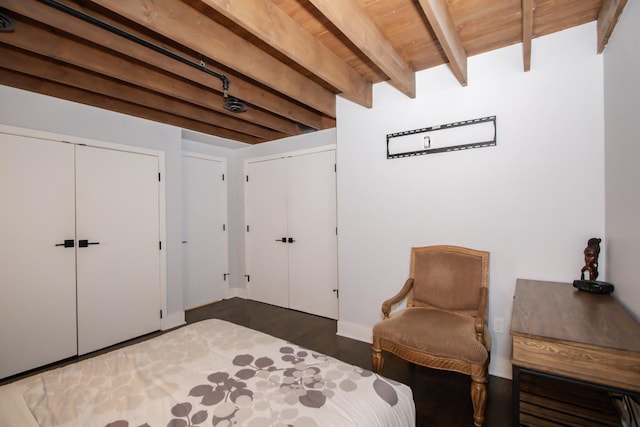 living area with beamed ceiling, wood finished floors, and wooden ceiling