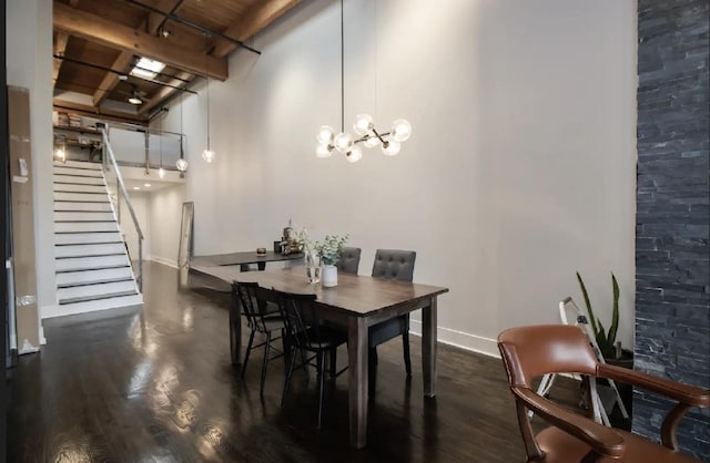 dining room with a notable chandelier, stairs, baseboards, and dark wood-style flooring