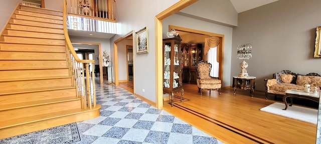 interior space featuring stairway, wood finished floors, and baseboards