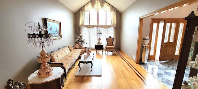 sitting room with visible vents, lofted ceiling, and wood finished floors