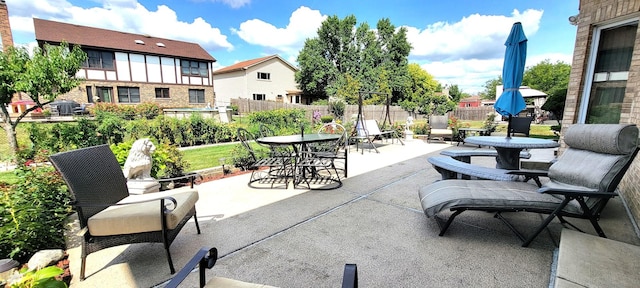 view of patio / terrace featuring outdoor dining space and fence