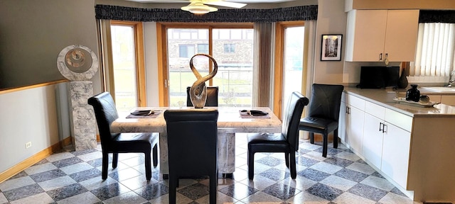 dining room with baseboards and ceiling fan