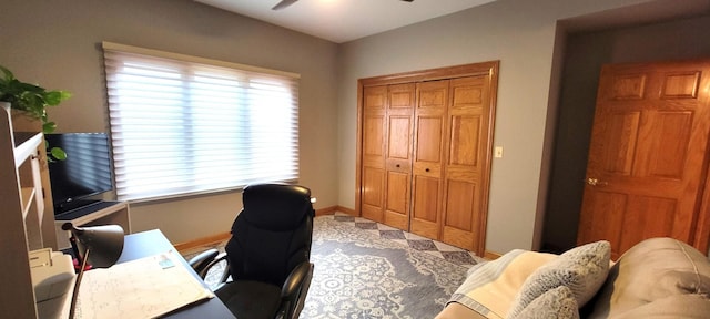 office area featuring baseboards and a ceiling fan