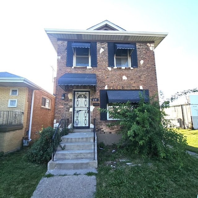 view of front of home featuring brick siding