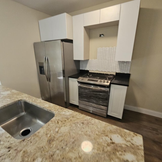 kitchen featuring white cabinets, appliances with stainless steel finishes, baseboards, and dark wood-style flooring