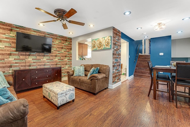 living room with stairs, recessed lighting, wood finished floors, and baseboards