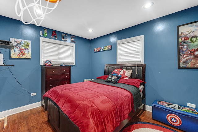 bedroom with recessed lighting, wood finished floors, and baseboards